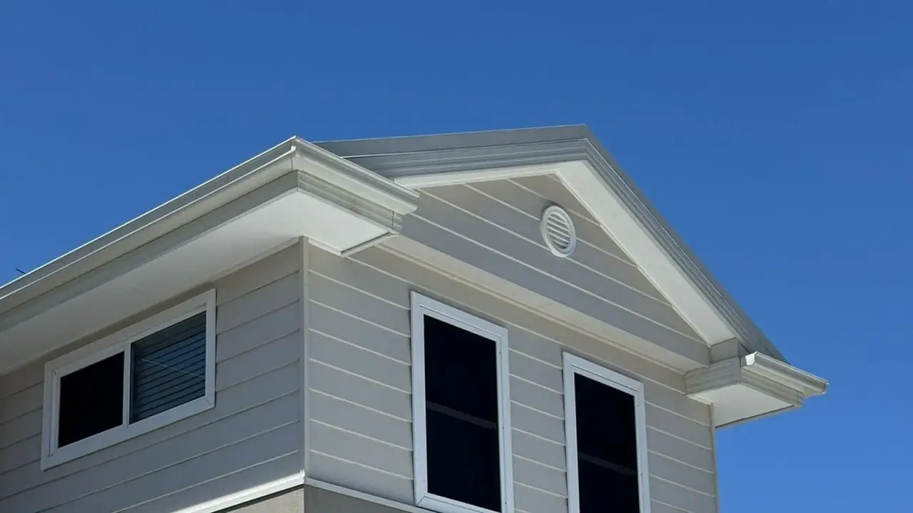 House cladding, eaves and exterior detail beneath a blue sky